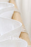 Close-up of white linen fabric with 'Linen Hue' branding.